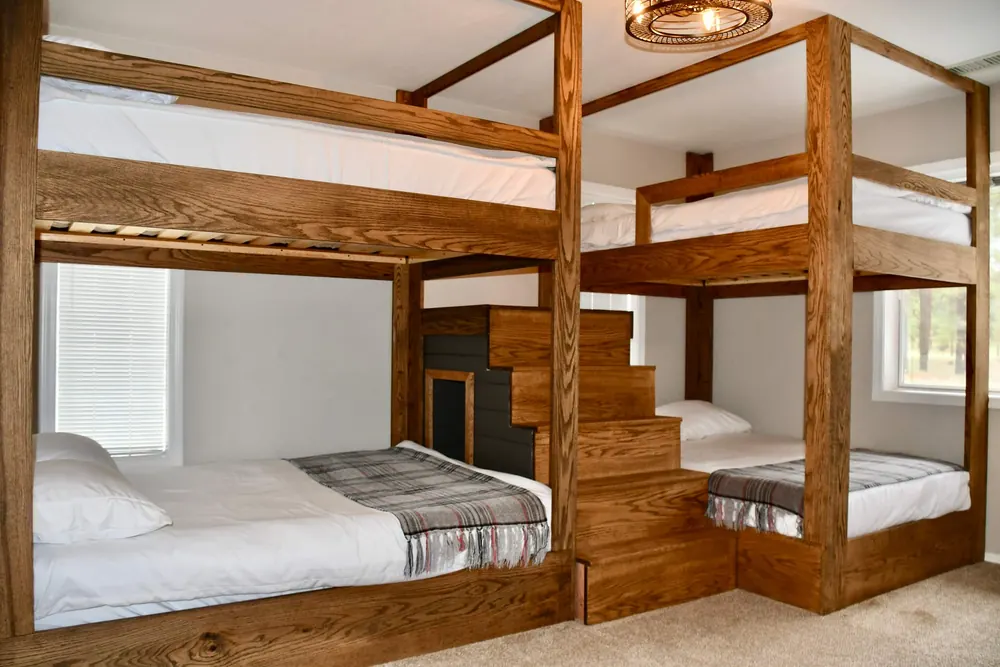 Two custom oak bunk beds with full mattresses in the Snowbowl Suite