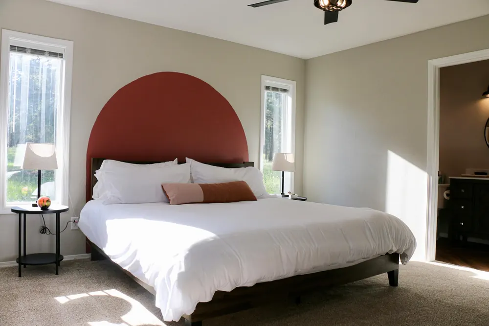King bed with an arched headboard in the Sedona Suite